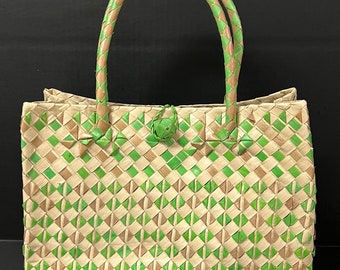 May include: A woven handbag with green and beige diamond patterns. The bag has two handles and a button closure.