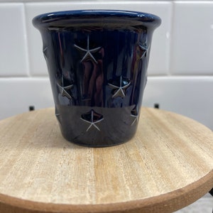 May include: A set of three ceramic mugs with a speckled, matte finish. The mugs are in shades of cream, light gray, and dark gray. Each mug has a simple, minimalist design, perfect for coffee or tea.