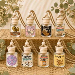 May include: Eight small glass car air freshener bottles with wooden caps and hanging ropes. Each bottle features a unique label with illustrations of cats or dogs and text including "Corn Chip Paws," "Feeling Fractious," "Kitty Magic," "Smells Like Kitty Biscuits," "Toe Bean Inspector," "Puppy Breath," "Serotonin Booster," and "Traz For The Spaz."