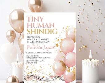 May include: A pink and gold baby shower invitation with the text "Tiny Human Shindig" and "Please join Megan and Jordan in welcoming baby Natalia Lynn". The invitation also includes the date, time, and location of the shower.