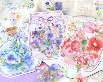 May include: Three watercolor illustrations of glass bottles filled with colorful flowers. The bottles are decorated with ribbons and have a vintage aesthetic.