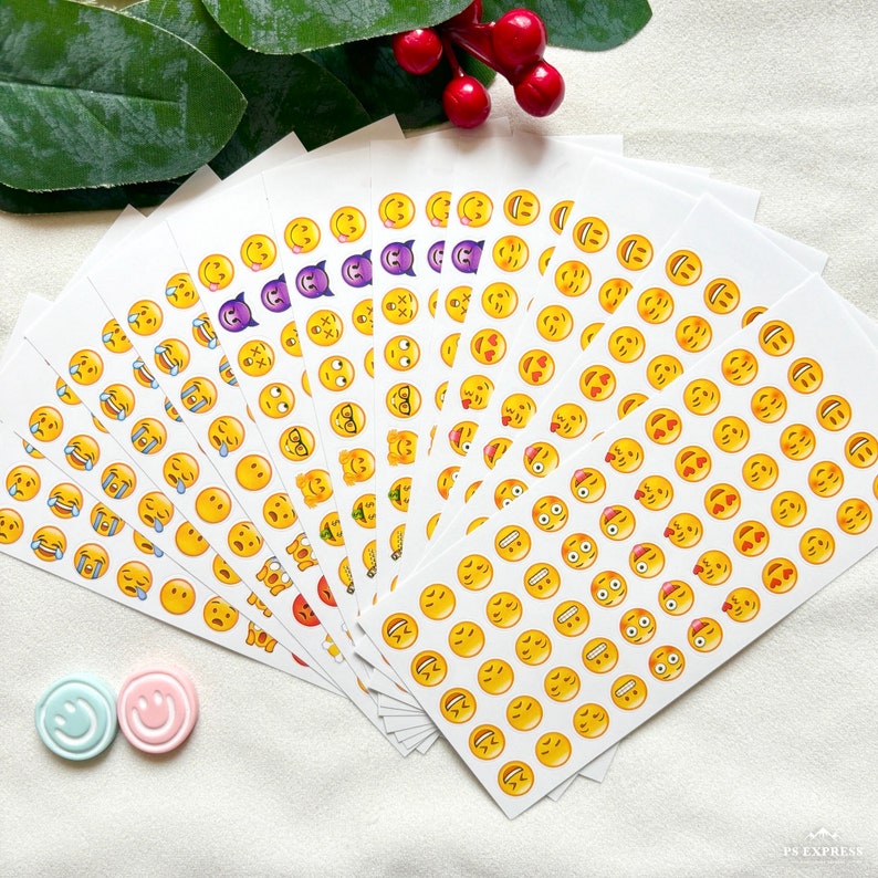 May include: A set of 20 sheets of colorful emoji stickers. Each sheet features a different emoji design, including smiling faces, hearts, and other popular icons. The stickers are perfect for adding a touch of personality to journals, laptops, and other items.