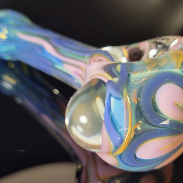 4" inside out color changing glass pipe with pink/purple sparkle flower design on the end