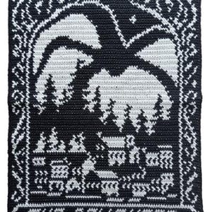Pode incluir: Quadrado de crochê em preto e branco com uma paisagem estilizada com uma grande silhueta de pássaro ou morcego. O design inclui árvores, um edifício e o texto "THE DEVOURER" na parte inferior. A borda tem um padrão ornamental.