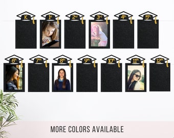 May include: A set of thirteen black glittery photo frames shaped like graduation caps, each labeled with a grade from K to 12th in gold. The frames are arranged in two rows, with some containing photographs of students, and the text MORE COLORS AVAILABLE.