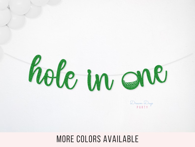 May include: A green glitter "hole in one" banner, perfect for a golf-themed party. The banner is strung on a white string and features a golf ball graphic. Additional colors are available.