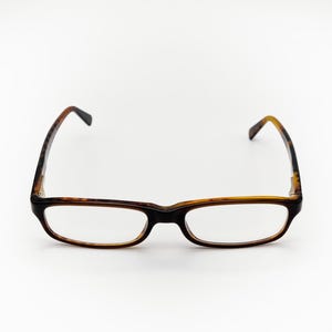 May include: A pair of tortoiseshell eyeglasses with clear lenses.