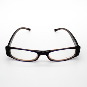 May include: Black rectangular eyeglasses with brown frames and blue tinted lenses. The brand name "dita" is printed on the right lens.