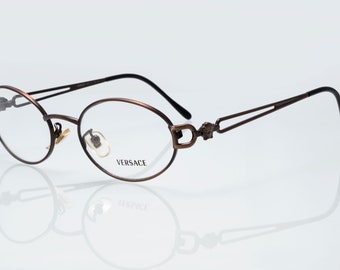 Gianni Versace vintage eyeglasses, mod. H68, medusa, bronze, oval optical frame made in Italy, new old stock