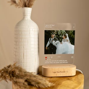 May include: A clear acrylic photo frame with a wooden base. The frame features a wedding photo of a couple and a caption that reads "I love you, not only for what you are, but for what I am when I am with you." The base is engraved with "Love You Forever".