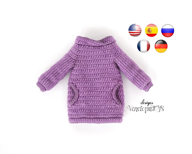 May include: Purple crocheted sweater with a turtleneck and two pockets. The sweater is made with a textured stitch and has a relaxed fit.