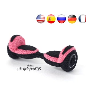 May include: A pink and black crocheted toy hoverboard. The toy is designed to look like a real hoverboard with two wheels and a platform in the middle.