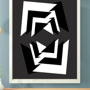 May include: Abstract geometric art print in a white frame. The artwork features a symmetrical design of black and white angular shapes on a dark gray background. The shapes create a dynamic, modern composition.