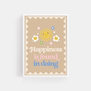 May include: A brown card with a scalloped border features a yellow sun with a smiling face and three white flowers with smiling faces. The text "Happiness is found in doing" is written in pink and blue letters.