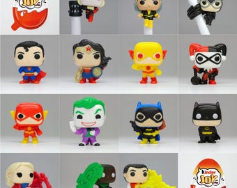 May include: A collection of 12 different DC Comics characters in the style of Funko Pop figures. The characters include Superman, Wonder Woman, The Flash, Joker, Batgirl, Batman, Harley Quinn, and more. The figures are all in a red and white Kinder Joy egg packaging.