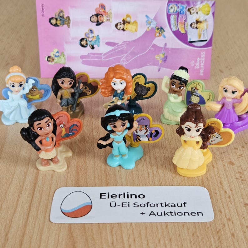 May include: A collection of ten Disney Princess figurines, each with a heart-shaped base featuring a character from the movie. The princesses include Cinderella, Pocahontas, Merida, Tiana, Rapunzel, Mulan, Jasmine, and Belle. The figurines are all in a standing position and are made of plastic.