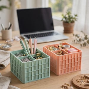 May include: Two square desk organizers with a grid-patterned exterior, one in light green and one in peach. Each container features four internal compartments filled with office supplies including pens, metal paper clips, and sticky notes.