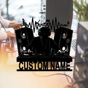 May include: Black silhouette of a DJ with headphones, mixing on a turntable, with two speakers and a sound wave graphic. The text "CUSTOM NAME" is below the DJ.