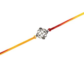 May include: A silver-colored bracelet with a decorative center piece. The bracelet features a woven cord in red, orange, and yellow. The center piece has an intricate design. The bracelet is displayed against a white background.