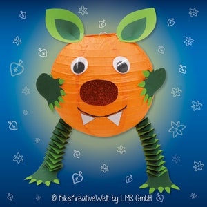 May include: A bright orange paper lantern shaped like a monster with green ears, arms, and feet. The monster has large eyes, a red nose, and a toothy grin. The lantern is decorated with glitter and has a white bow tie.