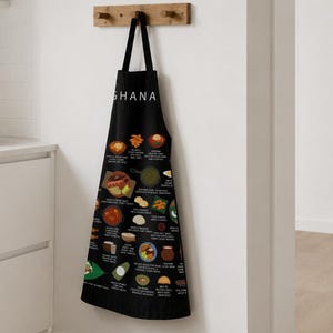 Ghana Food Apron featuring colorful illustrations of Jollof Rice, Kelewele, Fufu, Grilled Tilapia, Groundnut Soup, and Sobolo. Vibrant West African cuisine apron celebrating Ghana’s bold flavors and rich culture. Made from durable polyester canvas, perfect for home cooks and African food lovers. Ideal gift for foodies and travelers inspired by Ghanaian street food.