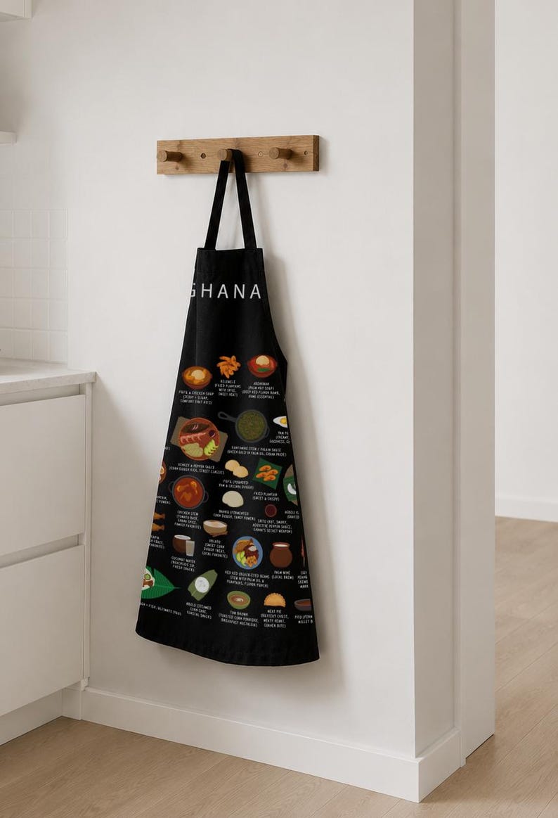 Ghana Food Apron featuring colorful illustrations of Jollof Rice, Kelewele, Fufu, Grilled Tilapia, Groundnut Soup, and Sobolo. Vibrant West African cuisine apron celebrating Ghana’s bold flavors and rich culture. Made from durable polyester canvas, perfect for home cooks and African food lovers. Ideal gift for foodies and travelers inspired by Ghanaian street food.