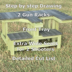 May include: A wooden shooting bench with a light green frame and gray tops. The bench features two gun racks, a front tray, and extra wide seats for two shooters. Text on the bench reads "Step by step Drawing", "2 Gun Racks", "Front Tray", "Extra Wide Seats for 2 Shooters", and "Detailed Cut List".