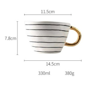 May include: White ceramic mug with black stripes and a gold handle. The mug is 11.5 inches wide, 7.8 inches tall, and 14.5 inches long. It holds 330 milliliters and weighs 380 grams.