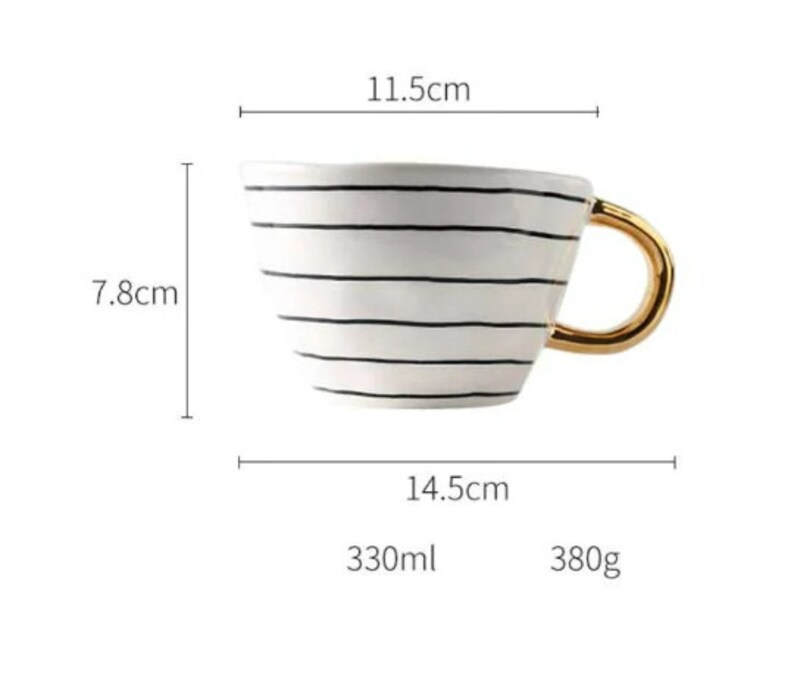 May include: White ceramic mug with black stripes and a gold handle. The mug is 11.5 inches wide, 7.8 inches tall, and 14.5 inches long. It holds 330 milliliters and weighs 380 grams.
