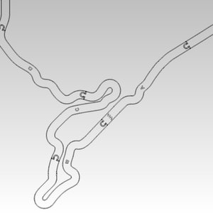 May include: A black and white line drawing of a race track with numbered turns. The track has a long straight away and a series of tight turns.