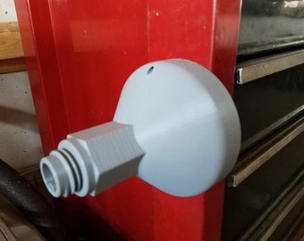 May include: A white plastic 3D printed adapter with a threaded connector and a round base. The adapter is mounted to a red surface.