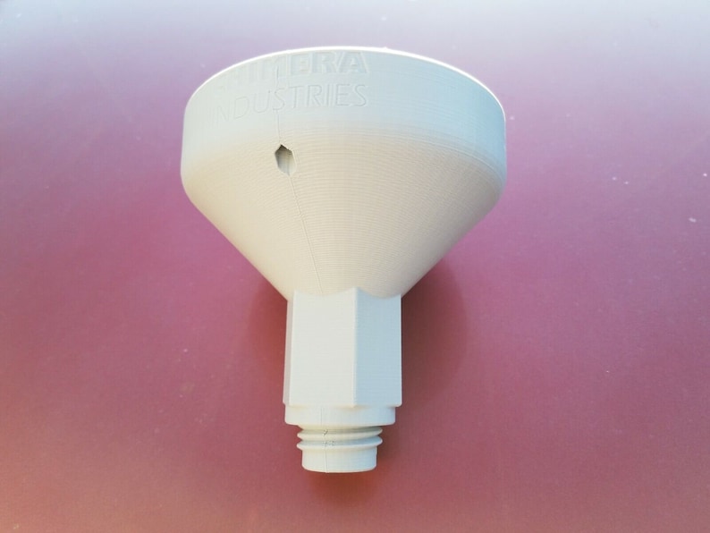 May include: White plastic funnel with the text "Cobra Industries" printed on the top. The funnel has a small hole in the top and a threaded opening at the bottom.