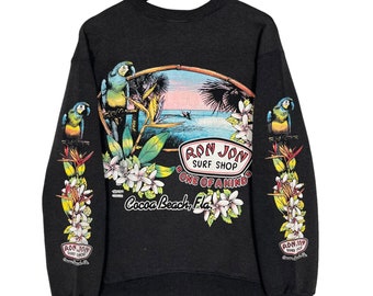 Bluza z okrągłym dekoltem i wyblakłym, vintage'owym nadrukiem z lat 90. Ron Jon Surf Shop w kolorze kakao, z nadrukiem tropikalnym, w kolorze czarnym, rozmiar M L, wyprodukowano w USA