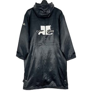 May include: Black hooded jacket with a white logo that says "Courreges" on the back.