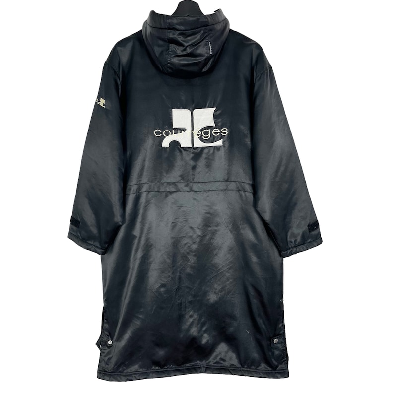 May include: Black hooded jacket with a white logo that says "Courreges" on the back.
