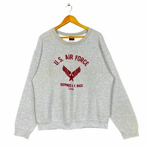 Könnte beinhalten: Grauer Sweatshirt mit einem roten gestickten US Air Force Logo und dem Text "Sheppard A.F. Base Texas".