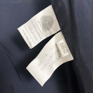 May include: White care label with the text "Dry Clean Only" and "1448 JA 82W" in Japanese. A second white label with the text "9AR 63", "100% Wool", "C-OS-168" in Japanese.