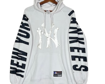 May include: White hooded sweatshirt with a large black and white New York Yankees logo on the front and the words "NEW YORK" and "YANKEES" printed vertically on the sleeves.