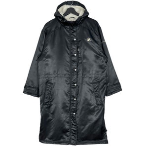 May include: A black long-sleeved hooded jacket with a zipper and button closure. The jacket has a fleece lining and a logo on the left chest.