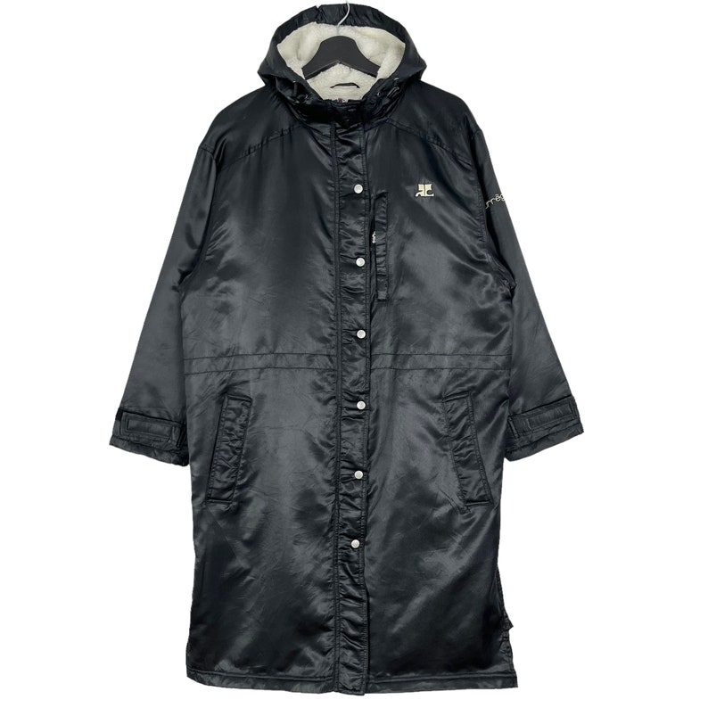 May include: A black long-sleeved hooded jacket with a zipper and button closure. The jacket has a fleece lining and a logo on the left chest.