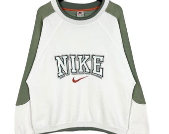Vintage 90-tals Nike-tröja med broderi och stavad logotyp, raglanärm, storlek Medium Large, tillverkad i Korea