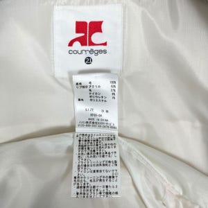 May include: A white garment tag with the Courr&egrave;ges logo in red and the number 21. The tag includes fabric composition details, size 38, and care instructions in Japanese. Made in China.