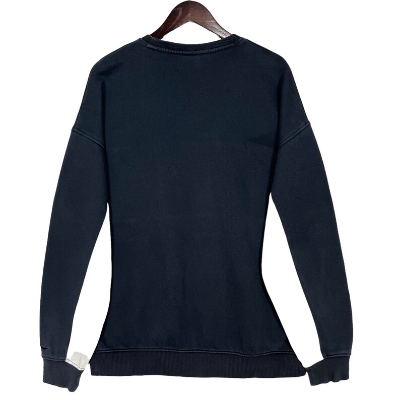 May include: Black long-sleeved sweatshirt with a crew neck.