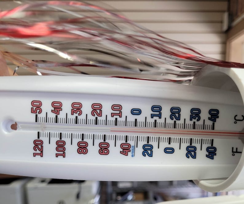 May include: A white thermometer with a red and blue scale shows a temperature of 20 degrees Fahrenheit and 0 degrees Celsius.