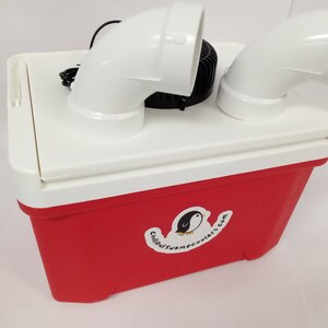May include: A red and white cooler with white PVC pipes and a black fan on top. The cooler has a sticker with a penguin logo and the text "ChillOutSwampCoolers.com".