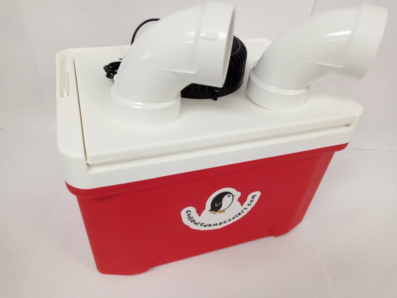 May include: A red and white cooler with white PVC pipes and a black fan on top. The cooler has a sticker with a penguin logo and the text "ChillOutSwampCoolers.com".