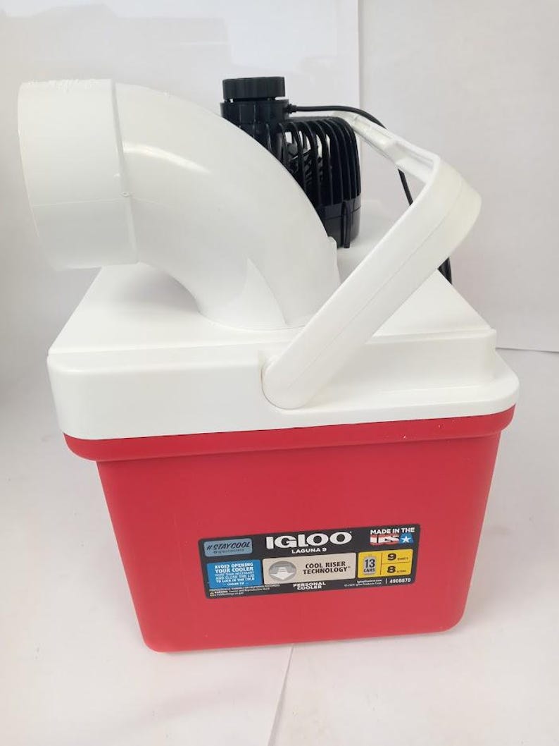 May include: A red and white Igloo Laguna 5 cooler with a white handle and a black motor attached. The cooler has a white top and a red base. The cooler is 13 inches long, 9 inches wide, and 8 inches high.