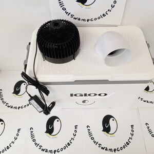 May include: A white Igloo cooler with a black fan, white vent, and power adapter. The cooler has the text "IGLOO" on the front. Several white circular logos with a penguin and the text "chilloutswampcoolers.com" are scattered around the cooler.
