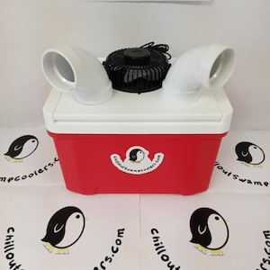 May include: A red and white cooler with a black fan and white air vents. The cooler has a logo with a penguin and the text "Chillout Swamp Coolers.com". The image also shows the logo repeated on the surface.