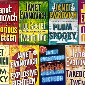 May include: A collection of Janet Evanovich novels, featuring titles like "Top Secret," "Explosive Eighteen," and "Sizzling Sixteen." The book covers display bold text and vibrant colors, with the author's name prominently displayed.